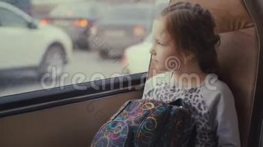 年轻漂亮的女乘客，在移动校车上带着书包，在她的智能手机和社交网络上使用社交网络